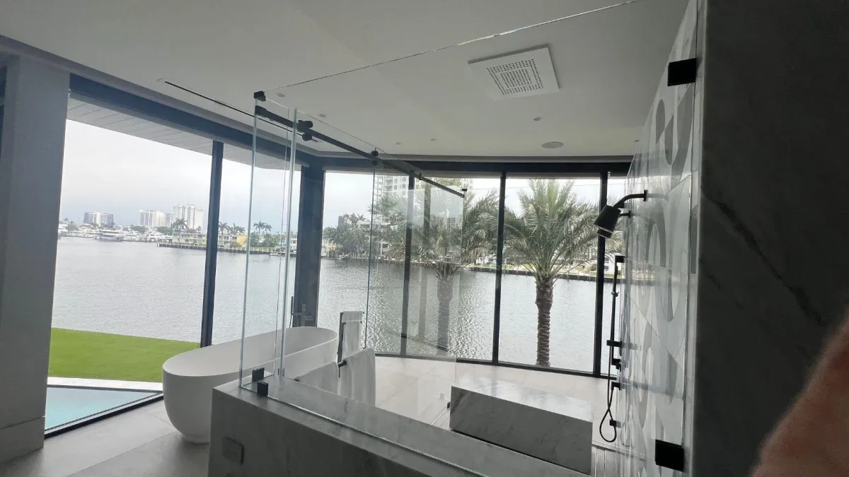 Glass shower partition beside a waterfront view