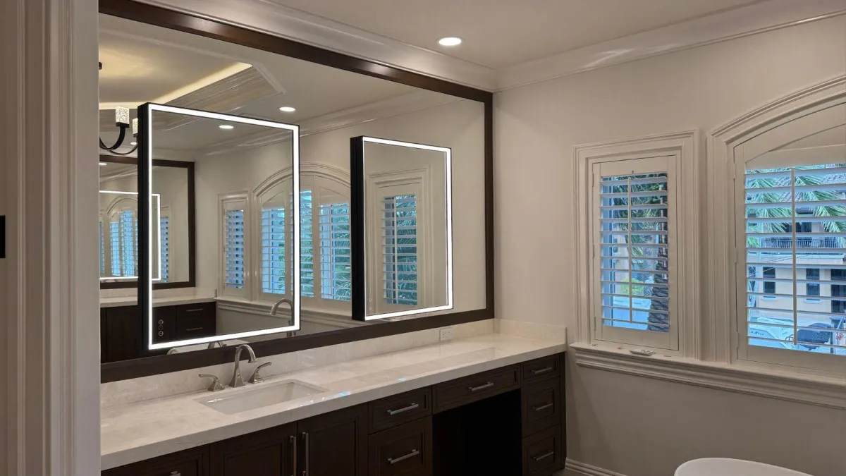 Installed illuminated vanity mirrors above a double basin